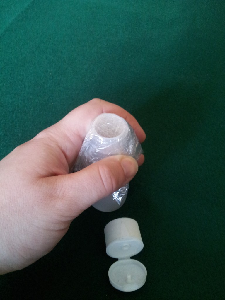 Place it over the mouth of the bottle and smooth it down.